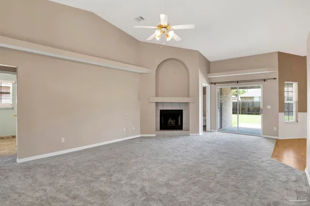 a view of an empty room with a fireplace