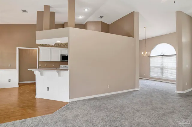 a view of a kitchen with a sink and a refrigerator