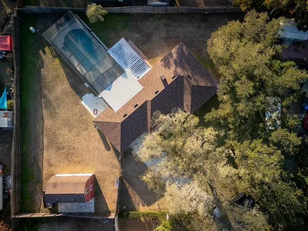 an aerial view of a house with a yard