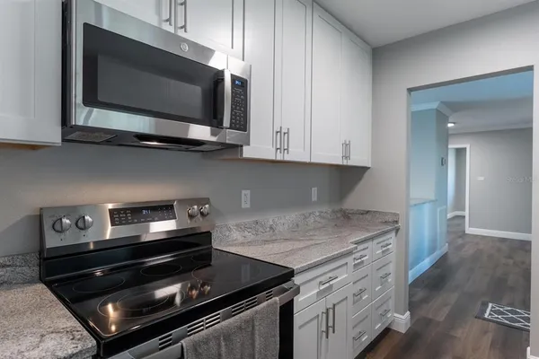 a kitchen with a stove and a microwave