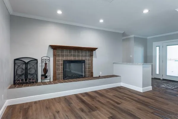 a living room with wooden floors and a fireplace