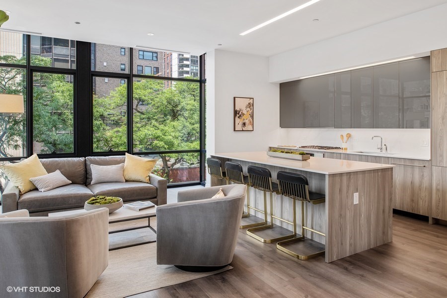 Undisclosed Address Chicago, IL 60610 - Photo 11 of 13 a living room with furniture a flat screen tv and a floor to ceiling window