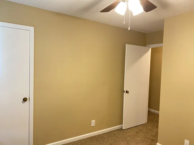 an empty room with a window and closet