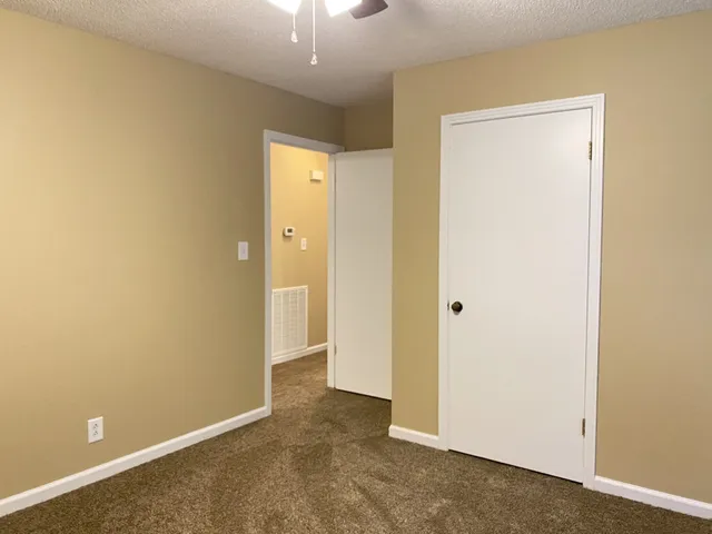 a view of a livingroom with a chandelier fan