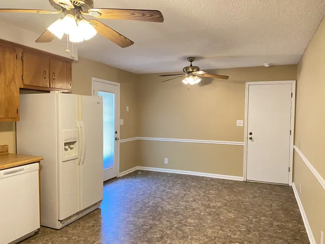 a view of hallway with shower and wooden floor