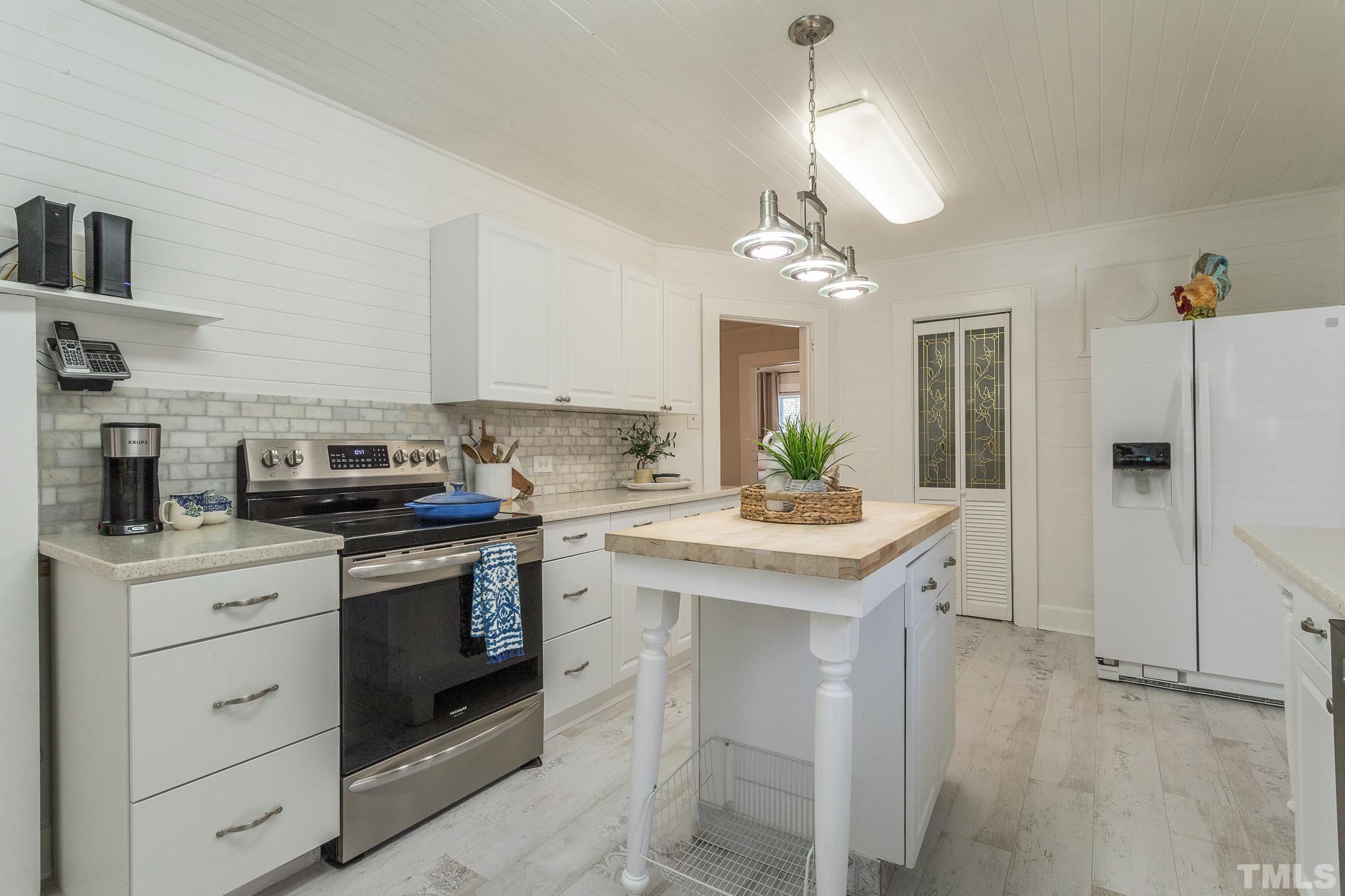 3620 Guess Road Durham, NC 27705 - Photo 13 of 41 a kitchen with a sink stove and refrigerator
