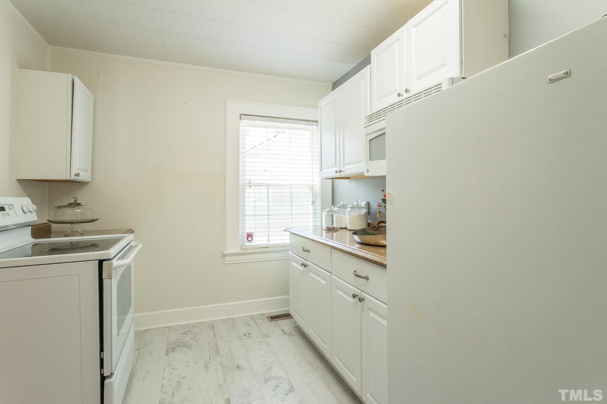 3620 Guess Road Durham, NC 27705 - Photo 14 of 41 a kitchen with a sink cabinets window and stainless steel appliances