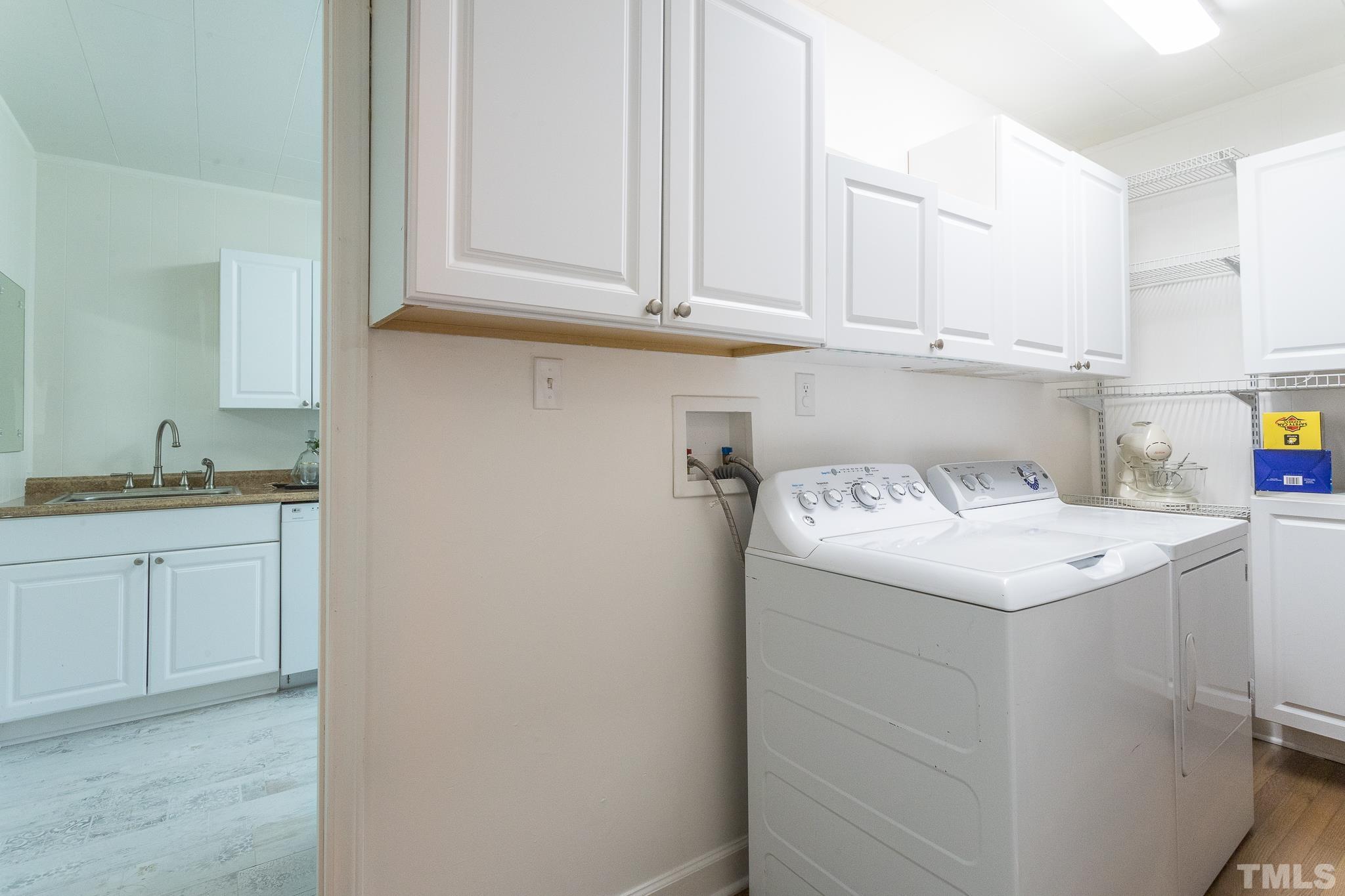 3620 Guess Road Durham, NC 27705 - Photo 15 of 41 a utility room with cabinets washer and dryer