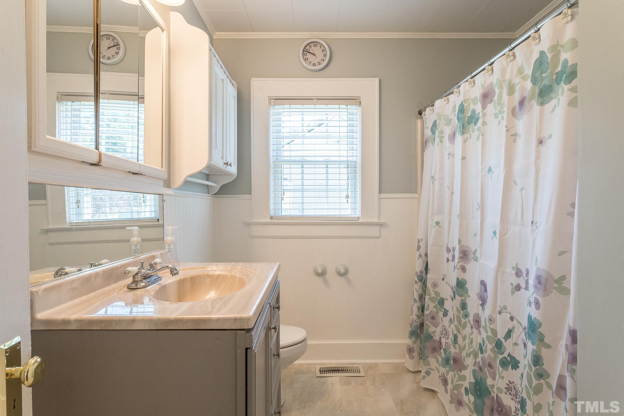 3620 Guess Road Durham, NC 27705 - Photo 19 of 41 a bathroom with a sink a mirror and a shower