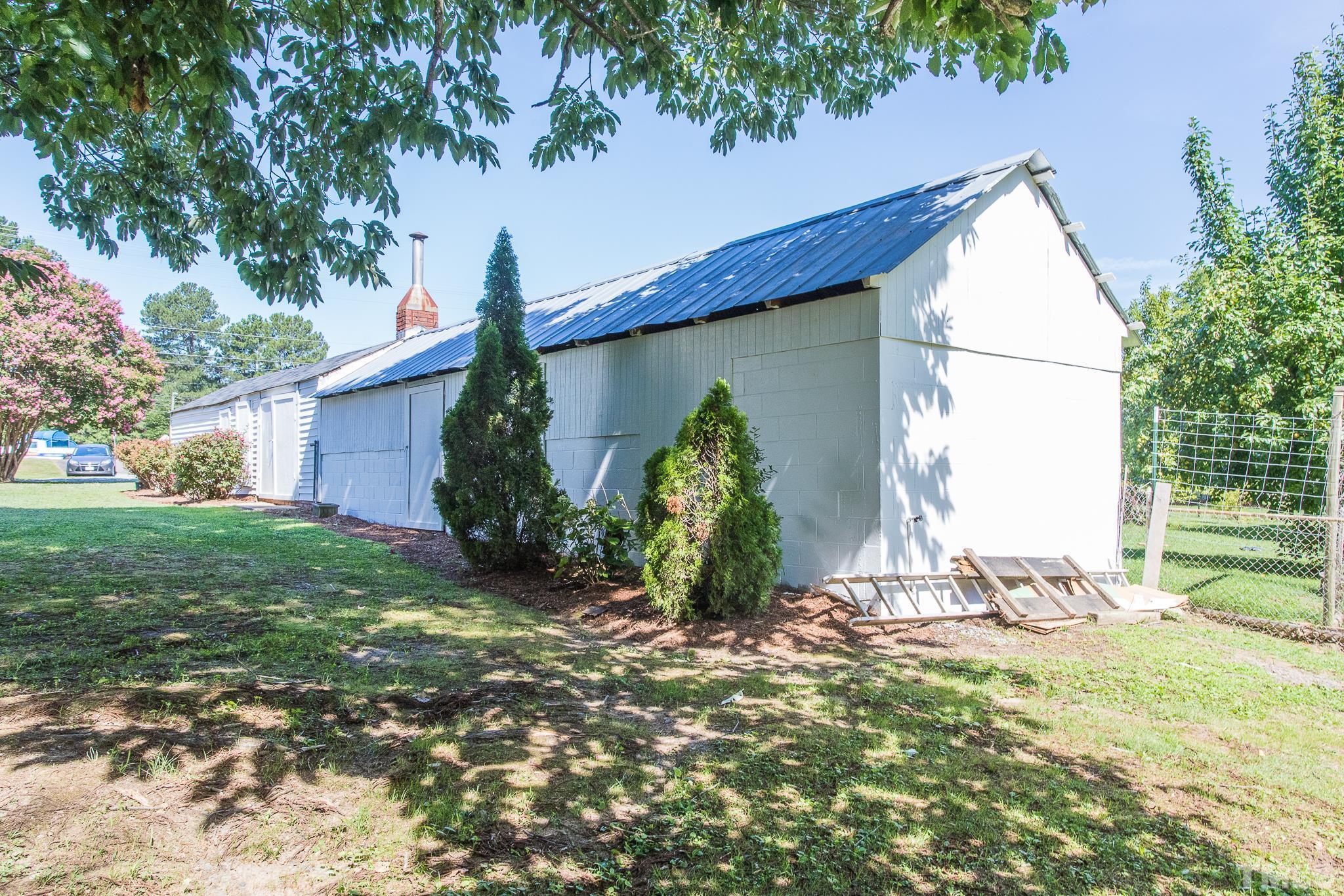 3620 Guess Road Durham, NC 27705 - Photo 31 of 41 a backyard of a house with potted plants and large tree