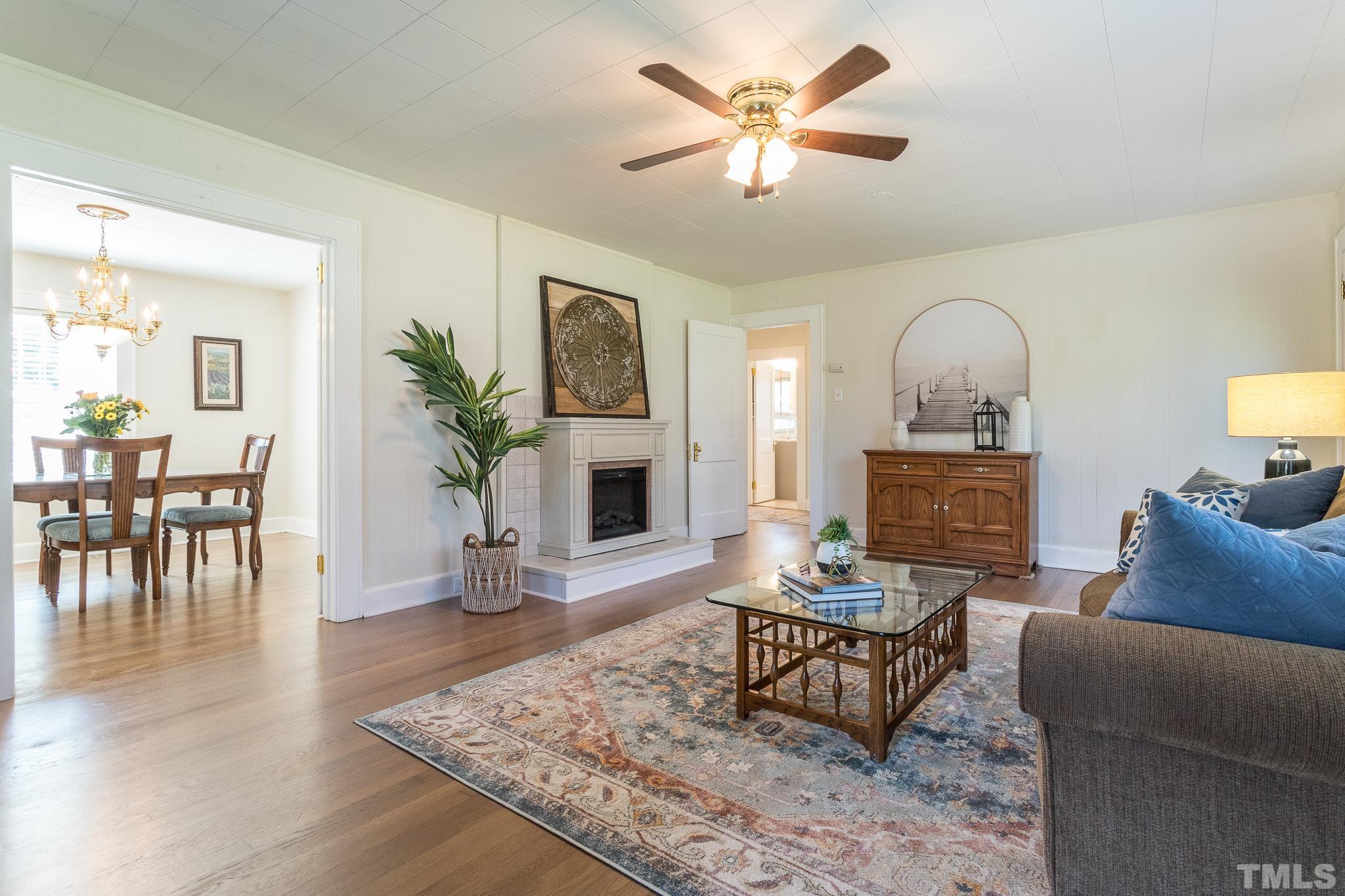 3620 Guess Road Durham, NC 27705 - Photo 4 of 41 a living room with furniture a fireplace and a table