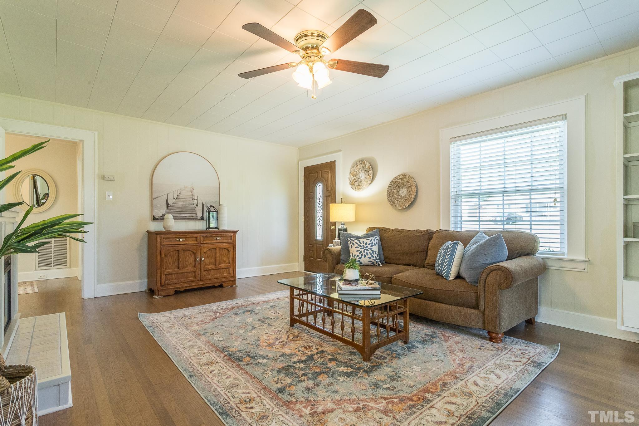 3620 Guess Road Durham, NC 27705 - Photo 5 of 41 a living room with furniture a fireplace and a table