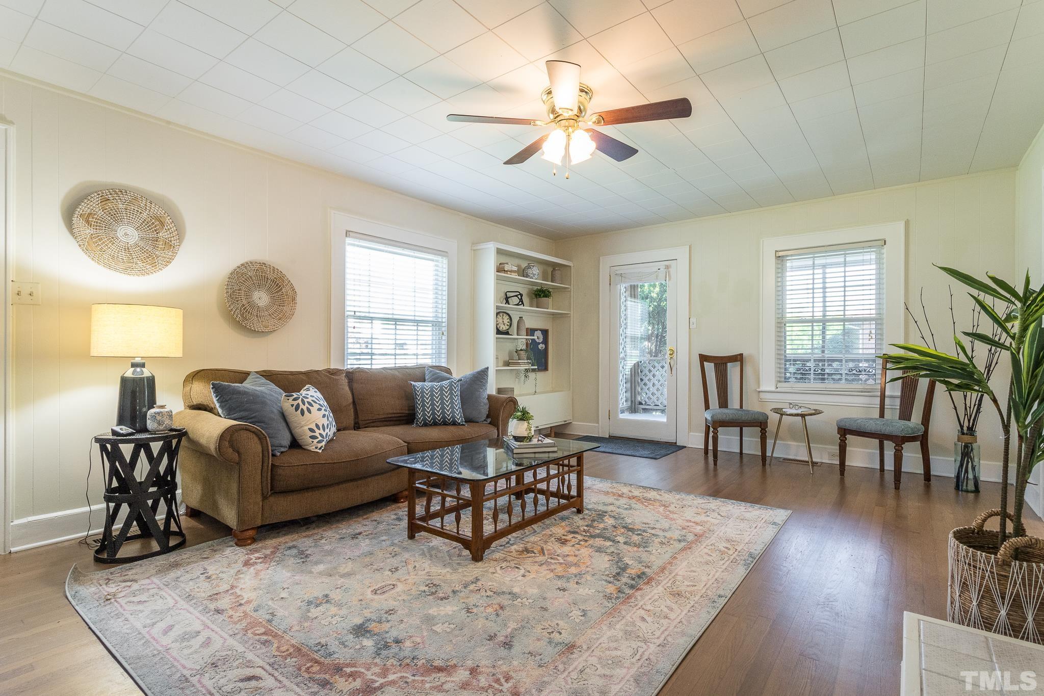 3620 Guess Road Durham, NC 27705 - Photo 7 of 41 a living room with couches a dining table and couches with wooden floor