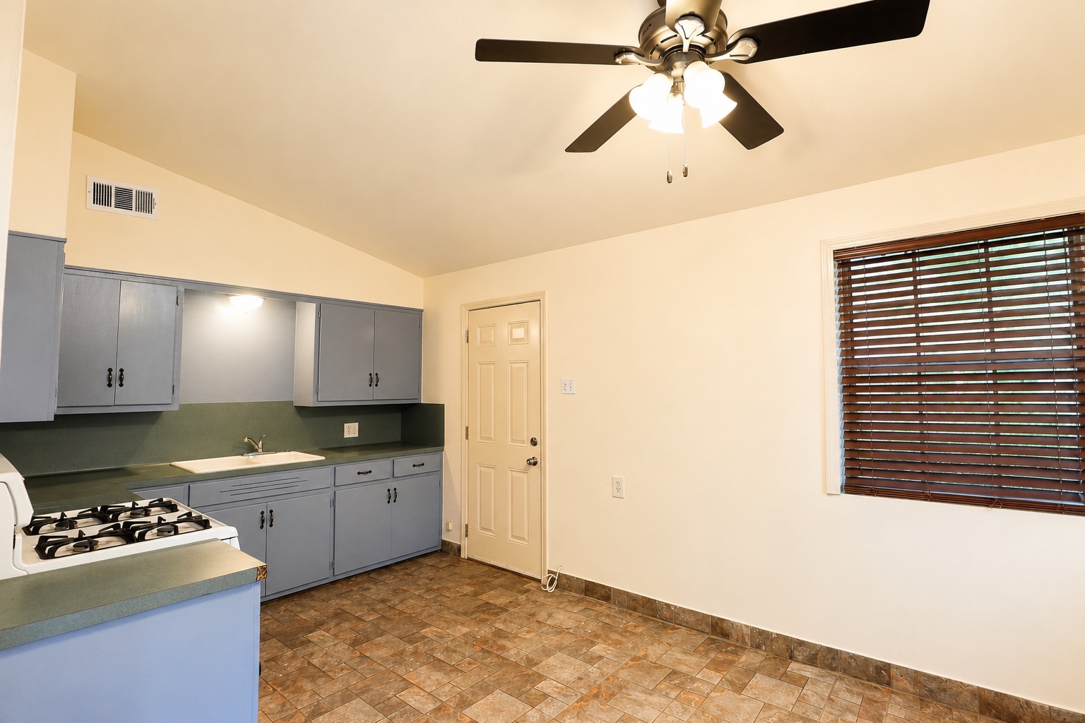 1508 Walnut Street Georgetown, TX 78626 - Photo 32 of 37 Functional kitchen with ample cabinet space, a gas range, and durable tiled flooring.