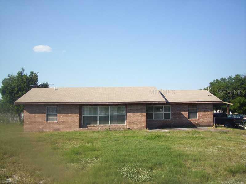 5812 Vaughn Road Bartow, FL 33830 - Photo 1 of 1 a front view of a house with a garden