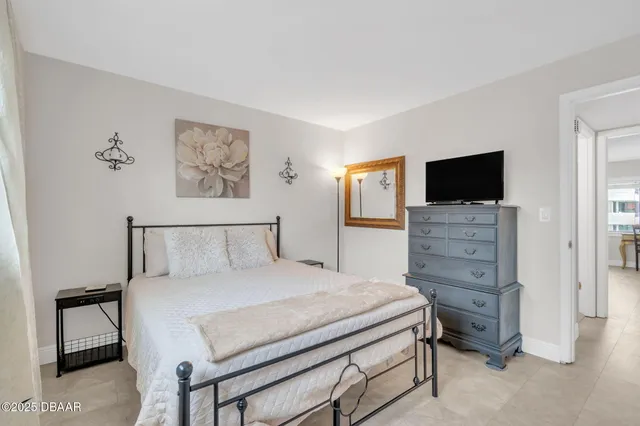 a bedroom with a bed and a television