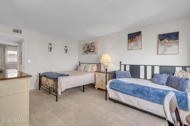 a spacious bedroom with a bed and a couch