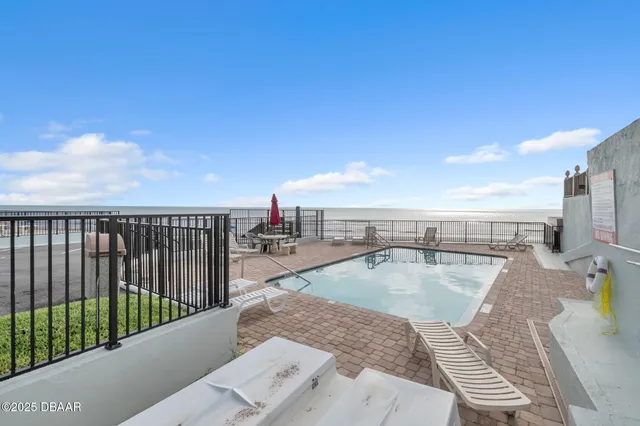 a view of a swimming pool with seating space