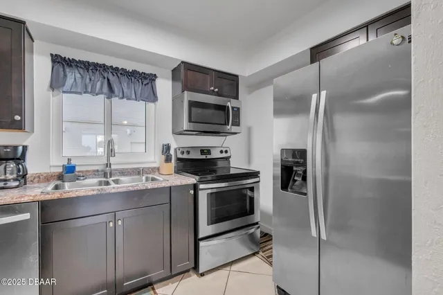 a kitchen with a sink stainless steel appliances and cabinets