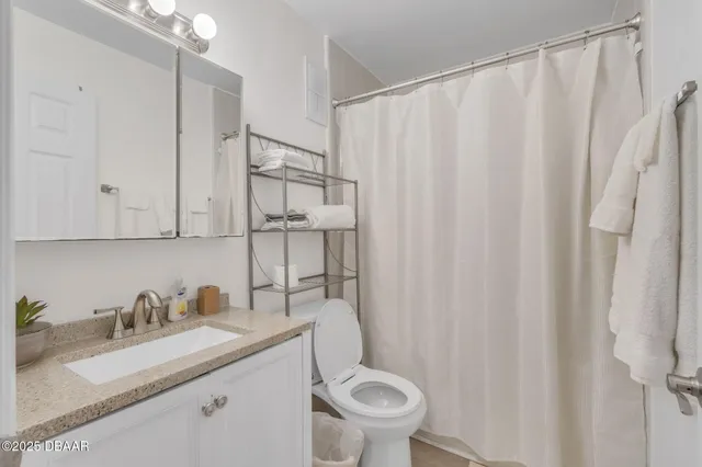 a bathroom with sink a mirror a toilet and vanity