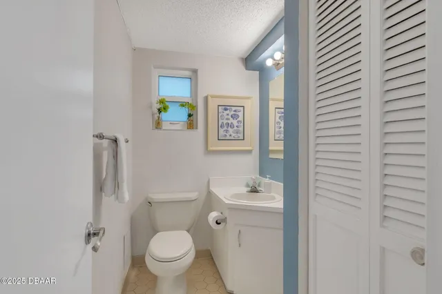 a white toilet sitting next to a bathroom sink