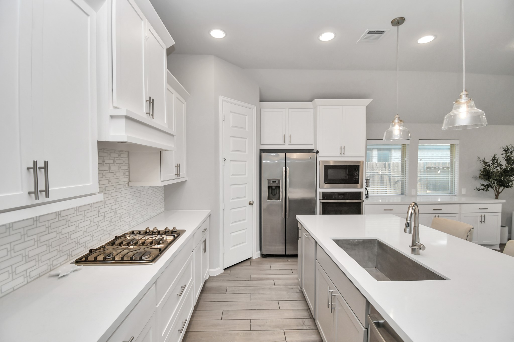 10522 Rigel Rdg Way Richmond, TX 77406 - Photo 11 of 41 a kitchen with stainless steel appliances kitchen island granite countertop a sink stove and refrigerator