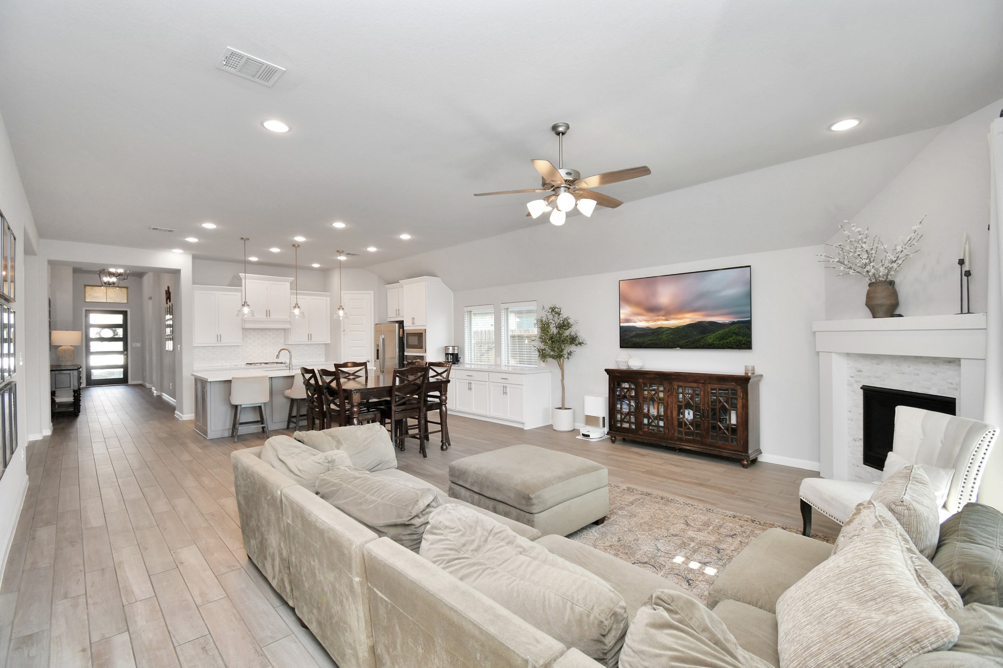 10522 Rigel Rdg Way Richmond, TX 77406 - Photo 12 of 41 a living room with furniture a fireplace and a flat screen tv