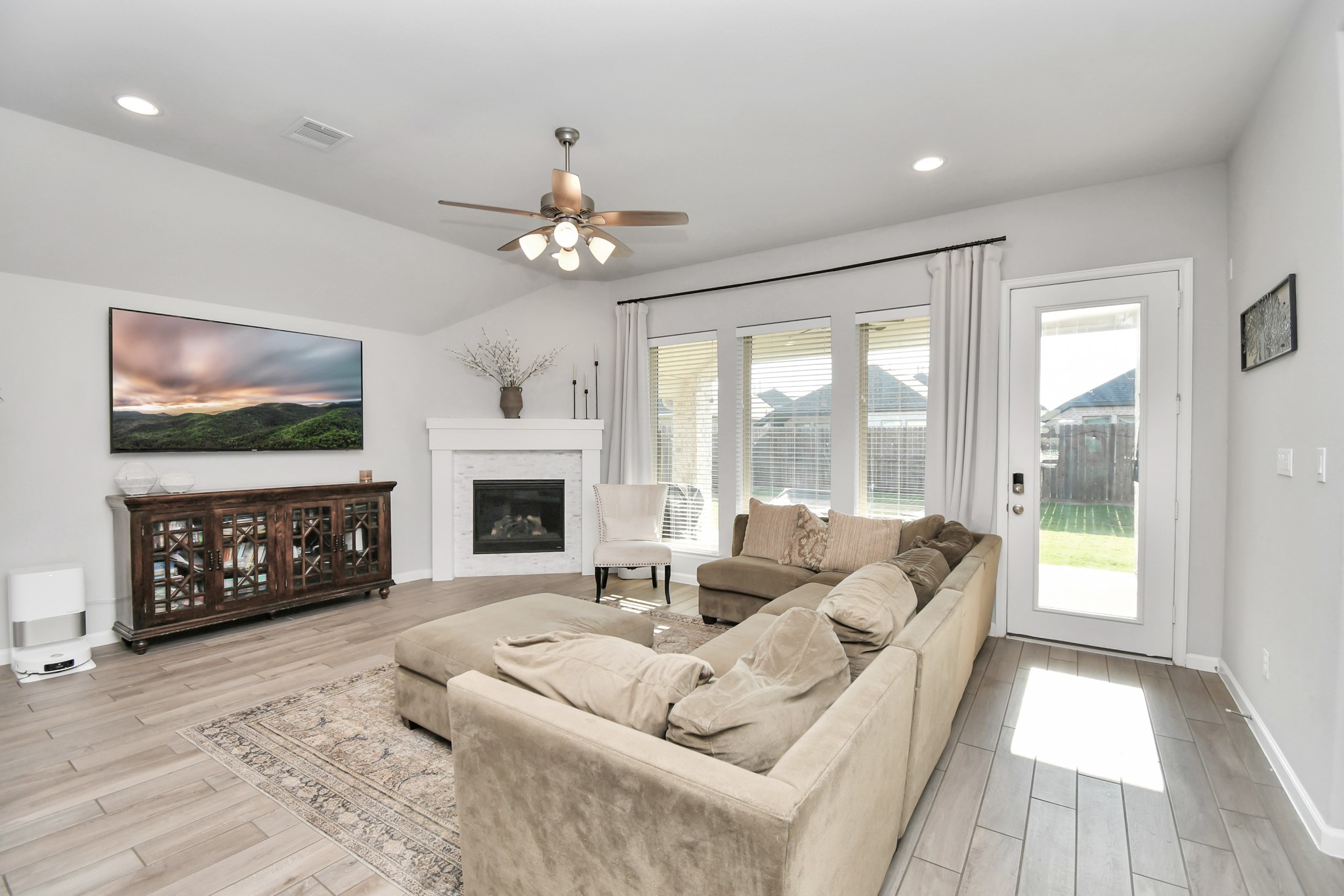 10522 Rigel Rdg Way Richmond, TX 77406 - Photo 14 of 41 a living room with furniture a fireplace and a flat screen tv