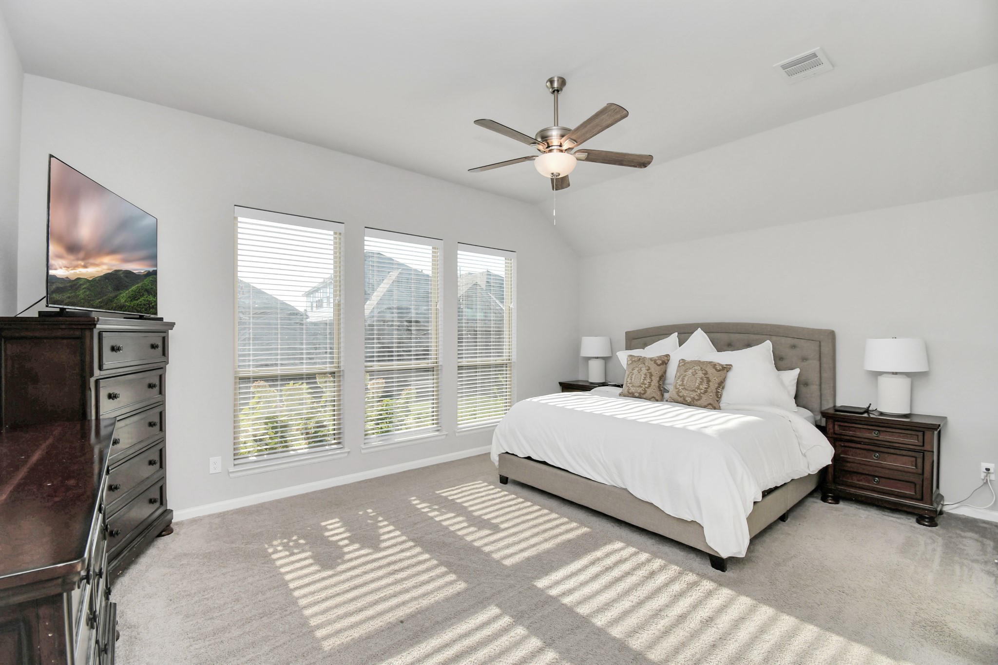 10522 Rigel Rdg Way Richmond, TX 77406 - Photo 15 of 41 a bedroom with a large bed and a tv