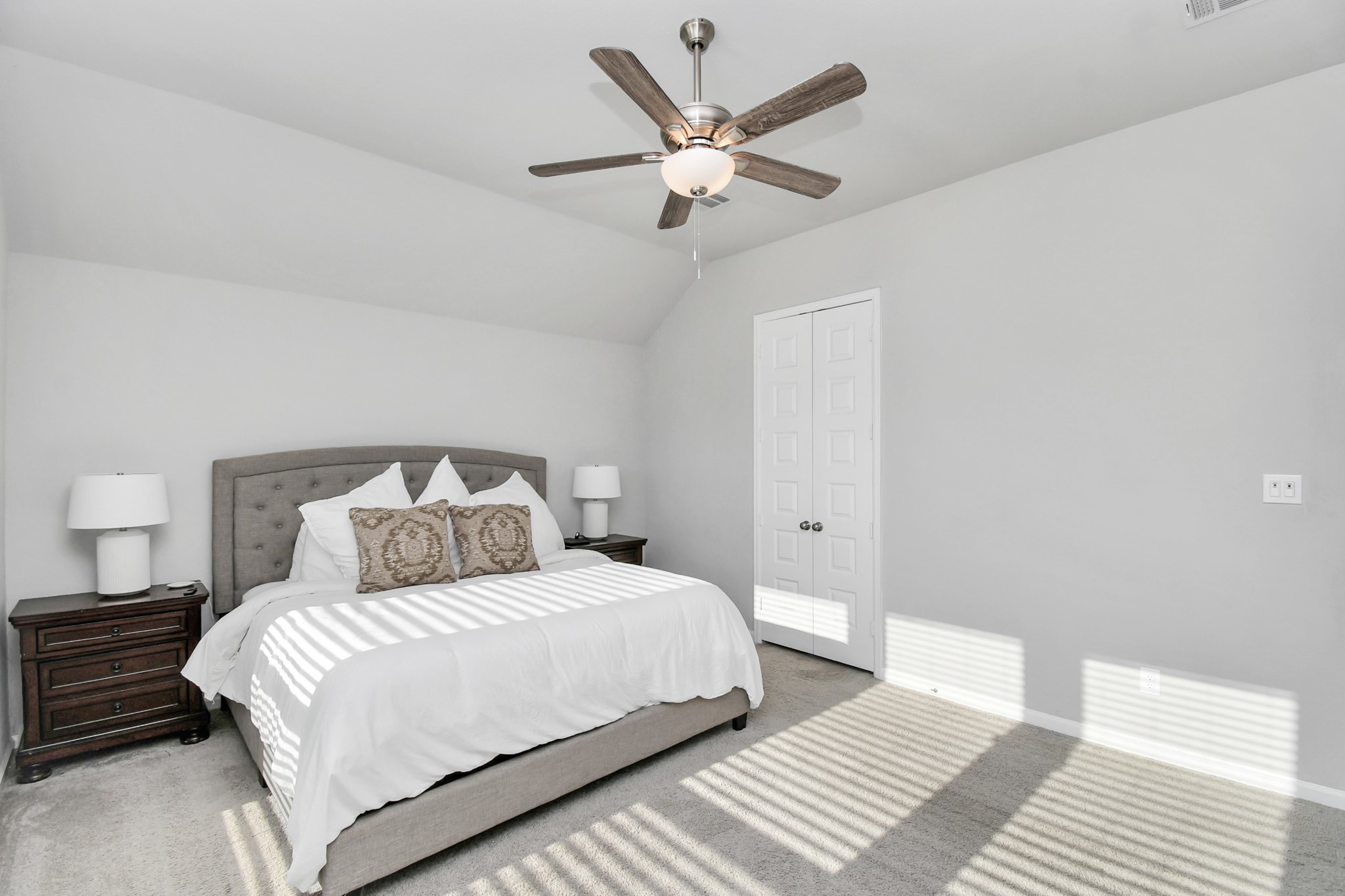 10522 Rigel Rdg Way Richmond, TX 77406 - Photo 16 of 41 a bedroom with a large bed and a ceiling fan