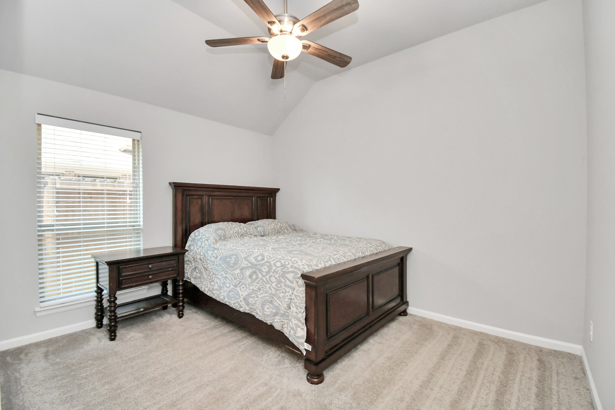 10522 Rigel Rdg Way Richmond, TX 77406 - Photo 20 of 41 a room with a bed and a ceiling fan