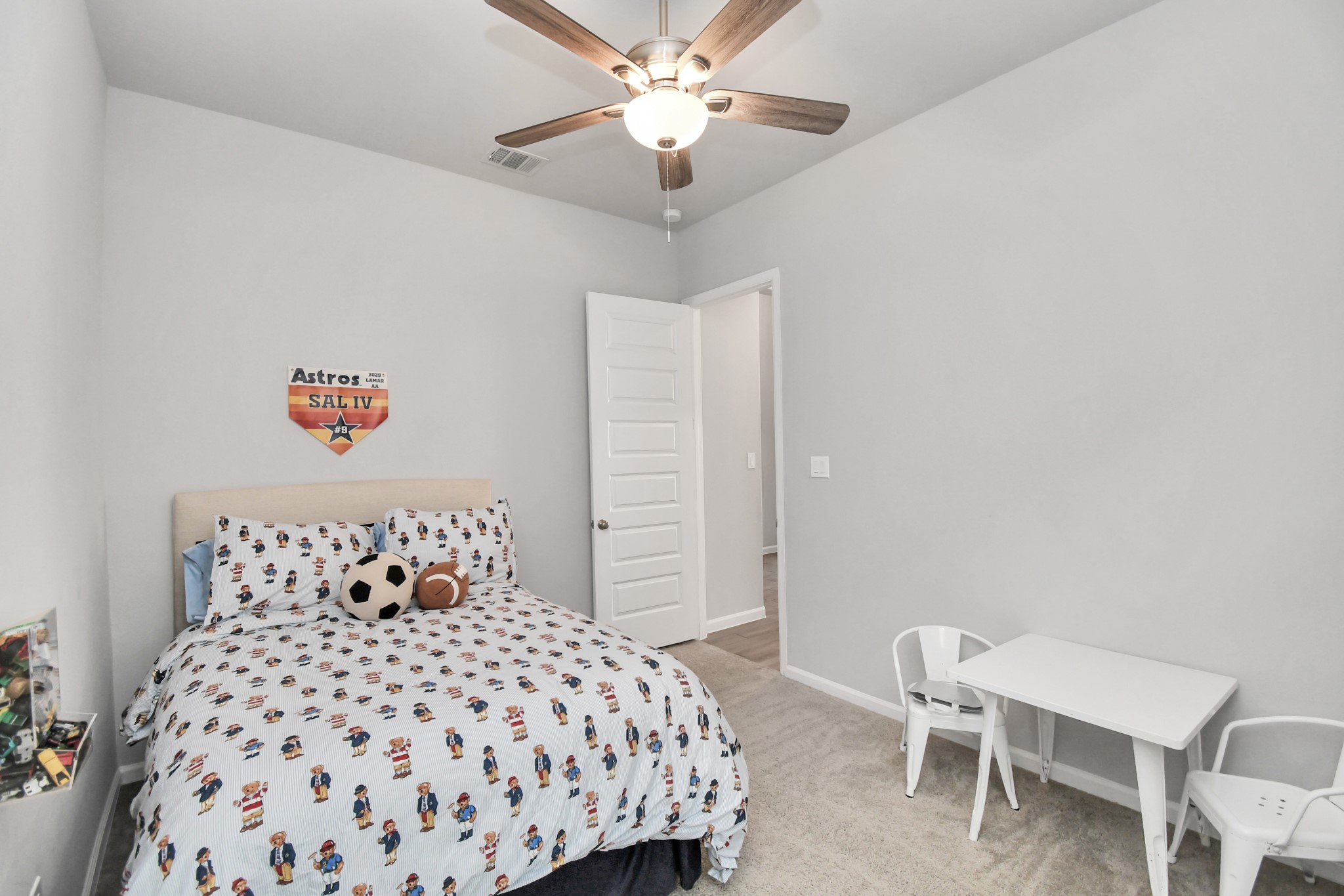 10522 Rigel Rdg Way Richmond, TX 77406 - Photo 25 of 41 a bedroom with a bed and a chandelier