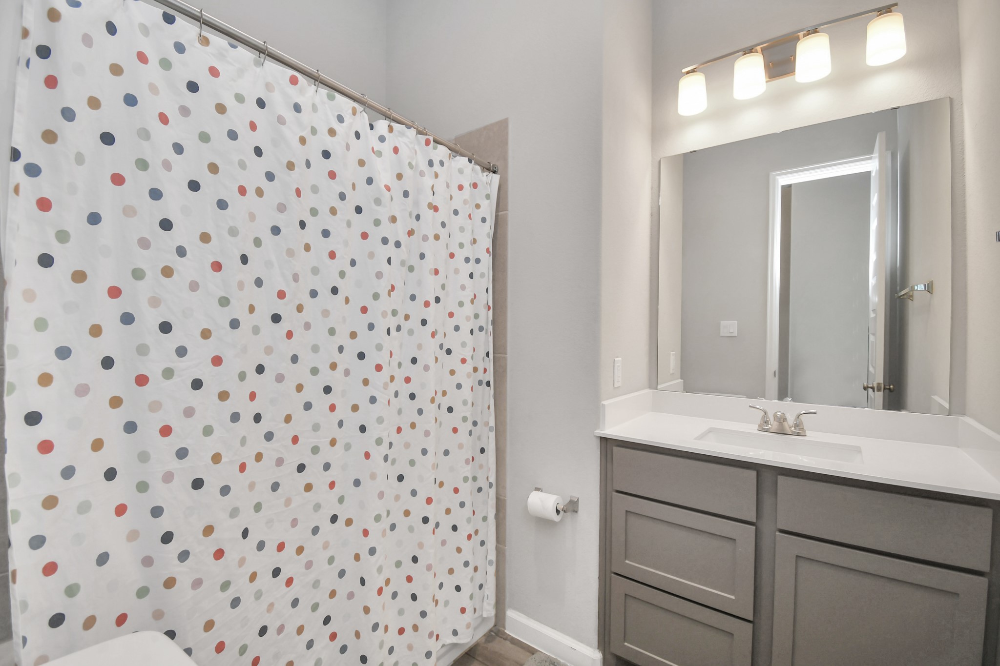 10522 Rigel Rdg Way Richmond, TX 77406 - Photo 26 of 41 a bathroom with a sink a vanity and a mirror