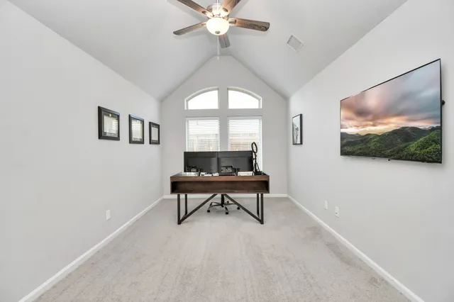a living room with furniture a rug and a flat screen tv