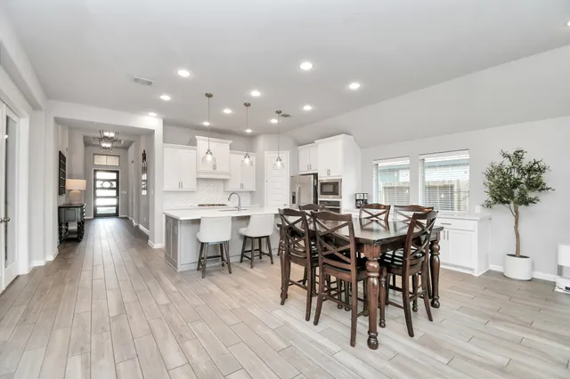 a view of a dining room with furniture and wooden floor