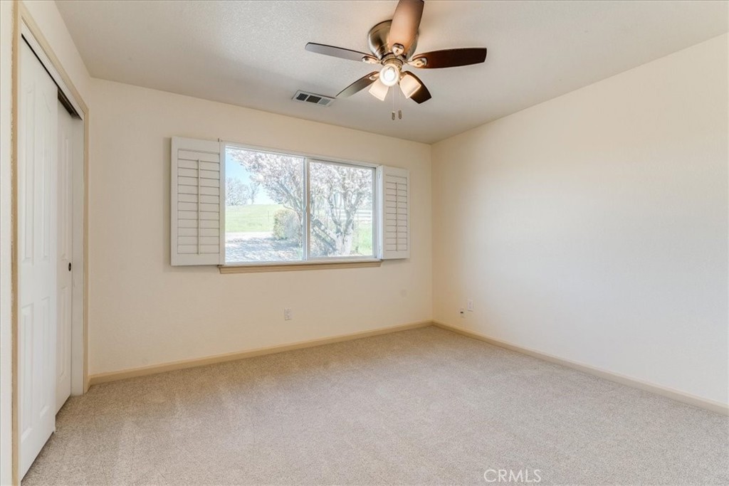 9305 Santa Lucia Road Atascadero, CA 93422 - Photo 21 of 41 an empty room with windows and fan