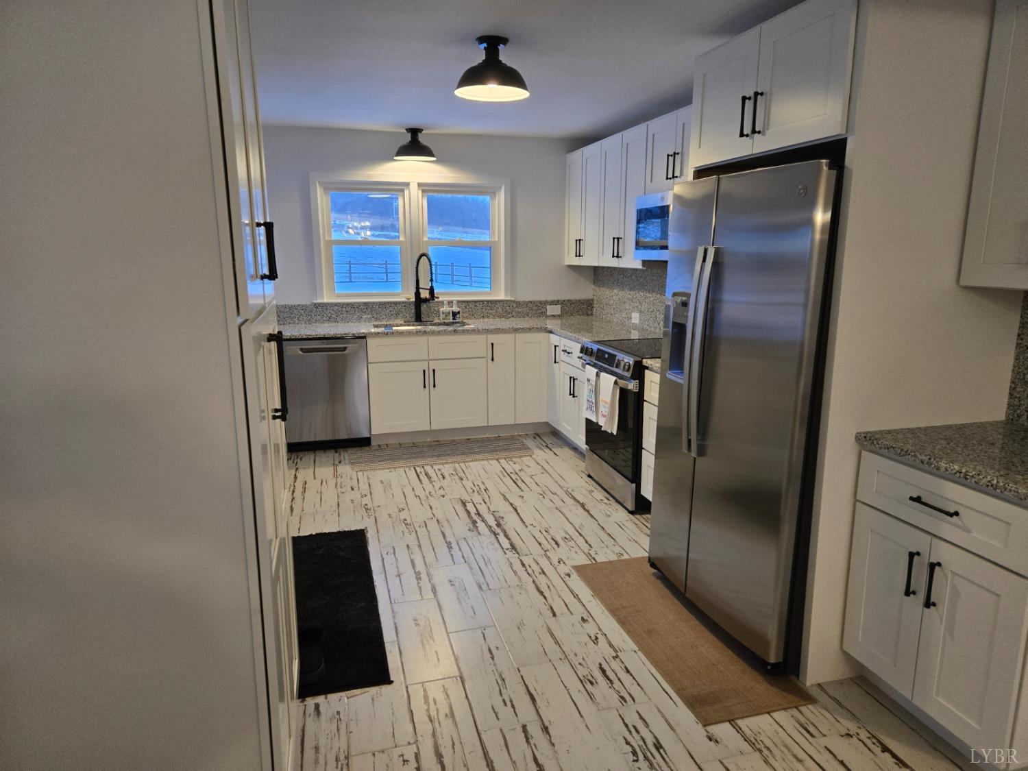 4015 White House Road Moneta, VA 24121 - Photo 12 of 35 a kitchen with stainless steel appliances a refrigerator and a stove