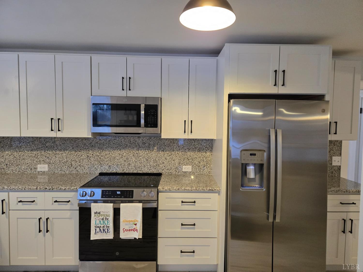 4015 White House Road Moneta, VA 24121 - Photo 13 of 35 a kitchen with white cabinets and stainless steel appliances