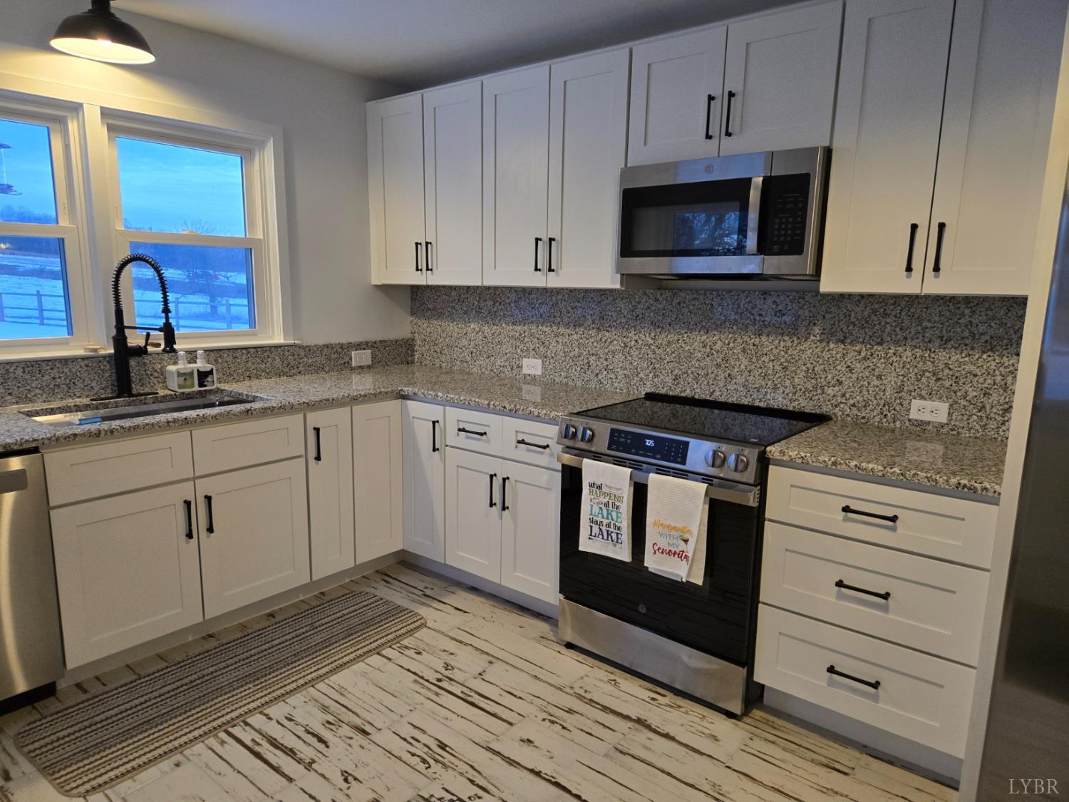 4015 White House Road Moneta, VA 24121 - Photo 15 of 35 a kitchen with granite countertop white cabinets stainless steel appliances and a sink