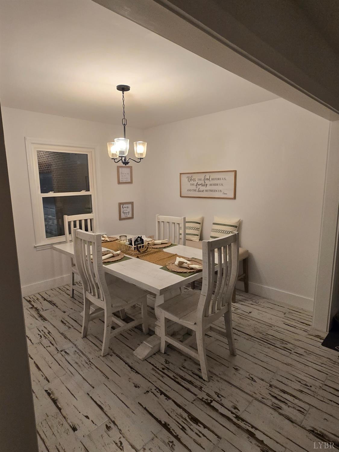 4015 White House Road Moneta, VA 24121 - Photo 20 of 35 a dining room with furniture a chandelier and wooden floor