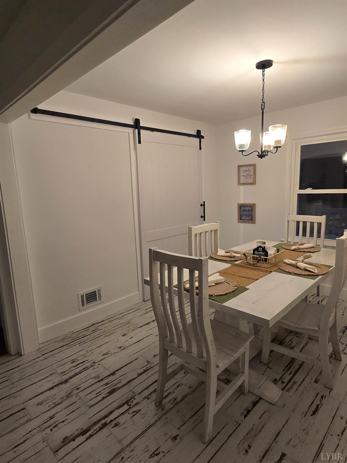 4015 White House Road Moneta, VA 24121 - Photo 21 of 35 a view of a dining room with furniture window and wooden floor