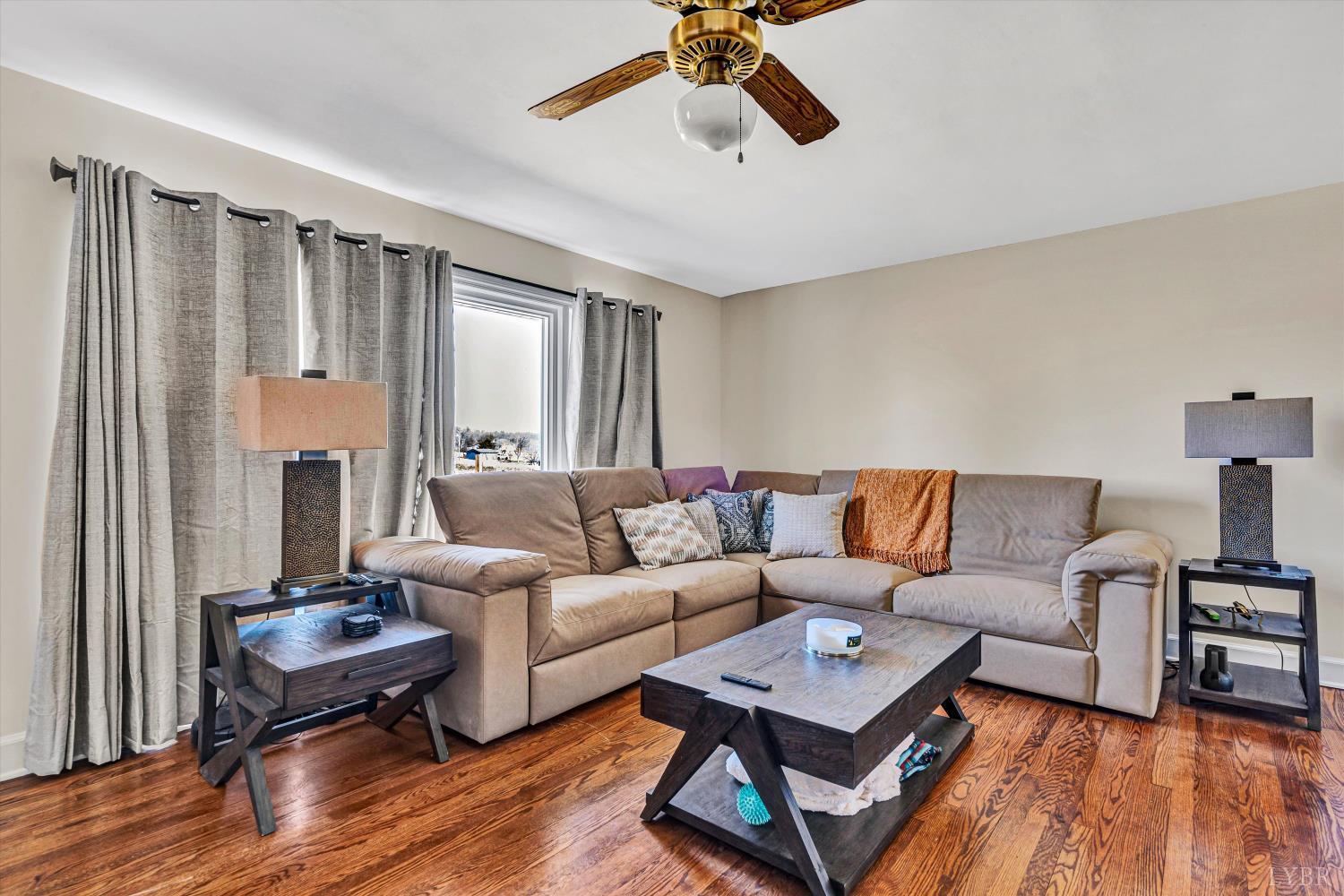 4015 White House Road Moneta, VA 24121 - Photo 5 of 35 a living room with furniture a table and wooden floor