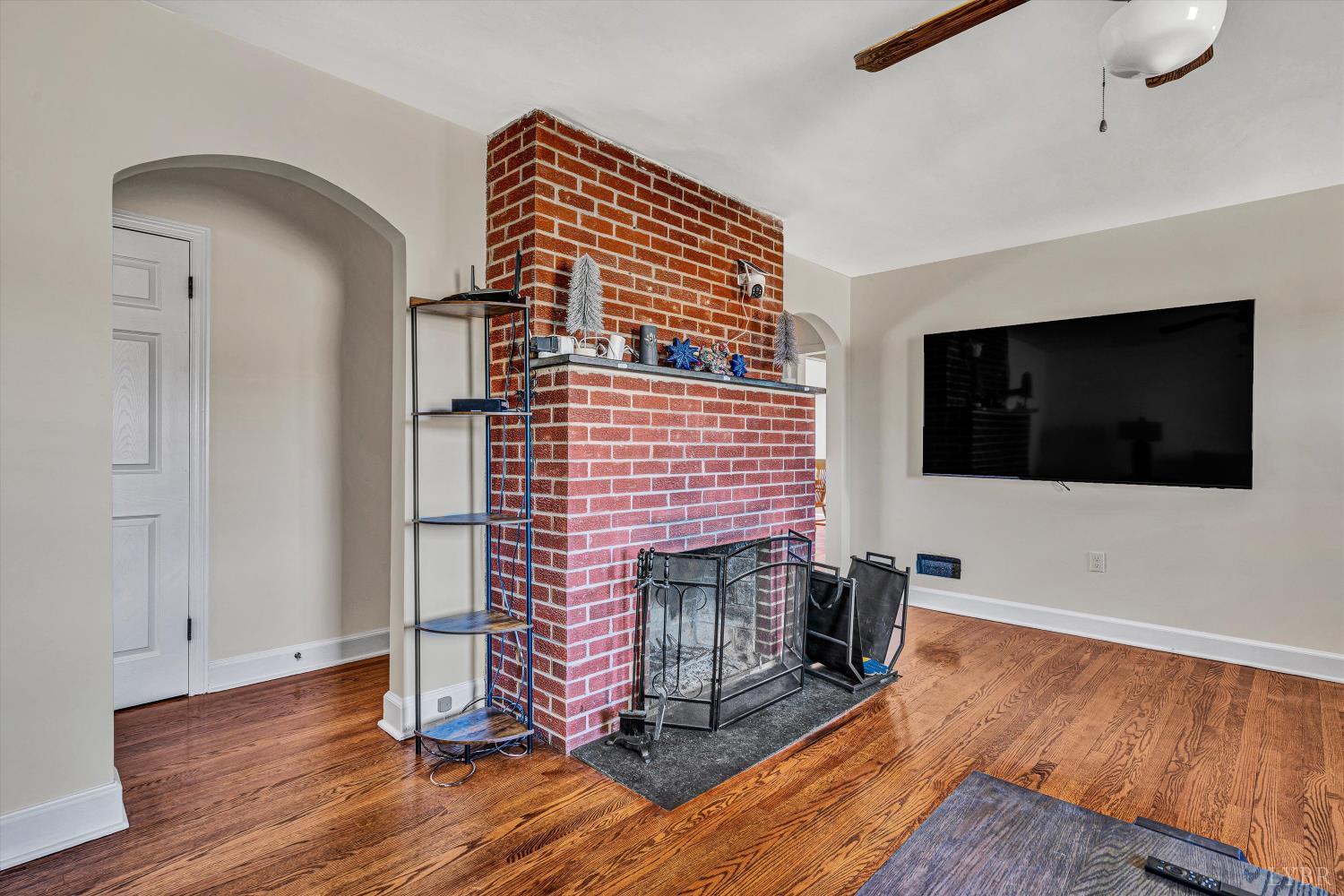 4015 White House Road Moneta, VA 24121 - Photo 6 of 35 a view of a livingroom with wooden floor and a fireplace