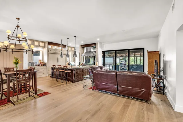 a kitchen with stove and chairs