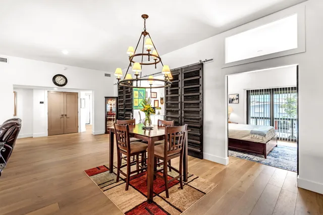 a living room with furniture a flat screen tv and a table