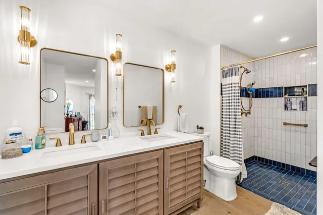 a spacious bedroom with a bed and wooden floor