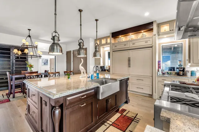 a kitchen with stainless steel appliances granite countertop a stove and a sink
