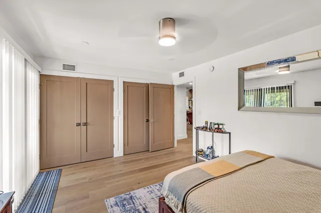 a bedroom with a large bed and a window