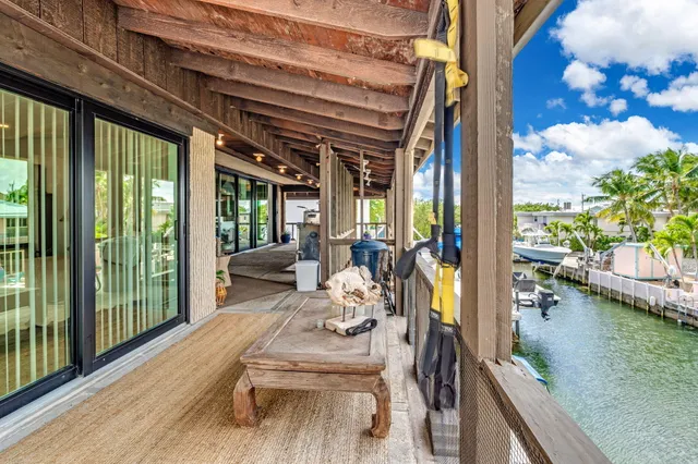 a dining room with wooden floor table and chairs
