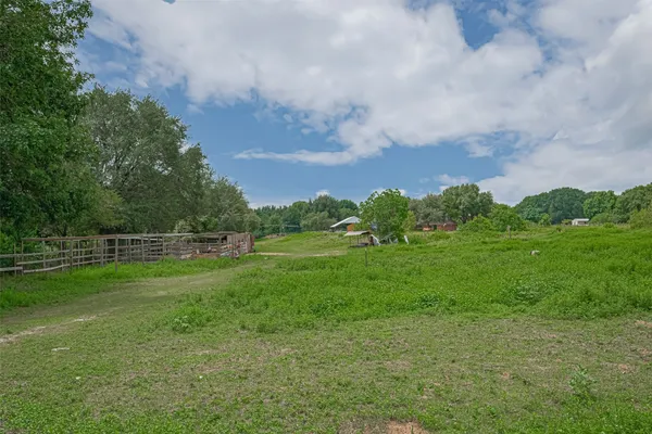 a view of a yard with grass and a houses